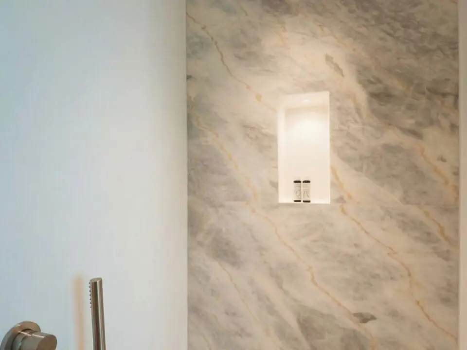 Junior Suite with Outdoor Hot Tub: Modern shower with marble-look tile, built-in niche, and handheld shower fixtures