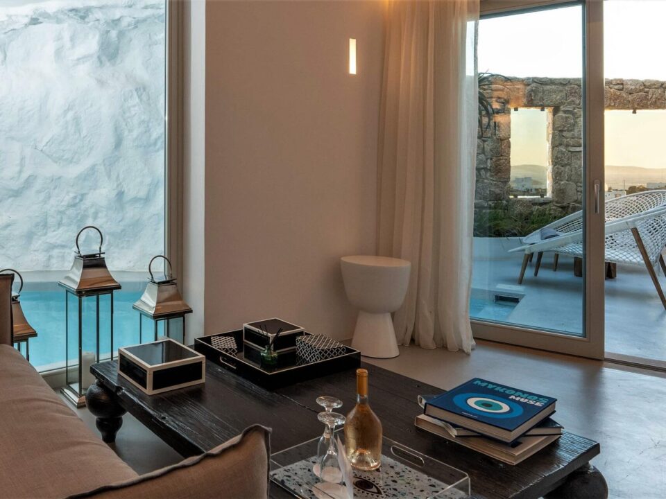 The Cave Pool Experience Suite: Luxury living room with a private pool and patio visible through large glass doors