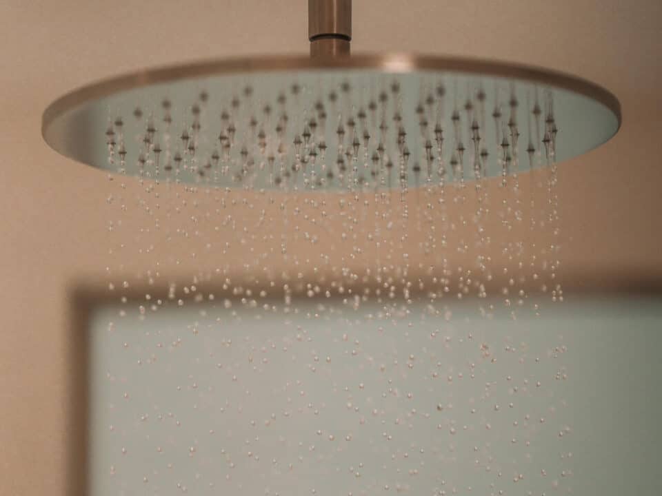 The Cave Pool Experience Suite: Rain showerhead spraying water