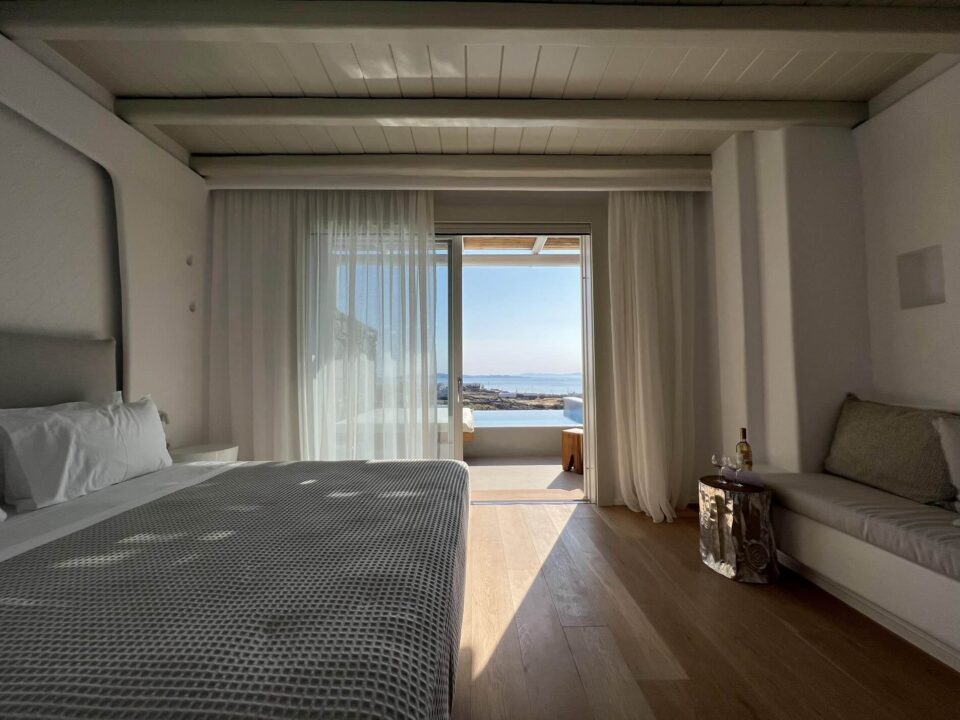 Junior Suite with Private Heated Swimming Pool: Bedroom with a sea view through sliding glass doors