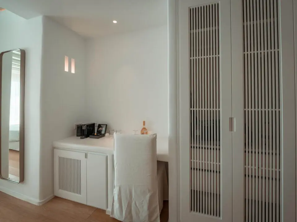 Premium Suite with Private Heated Swimming Pool: Minimalist bedroom vanity with full-length mirror, chair, and wardrobe doors