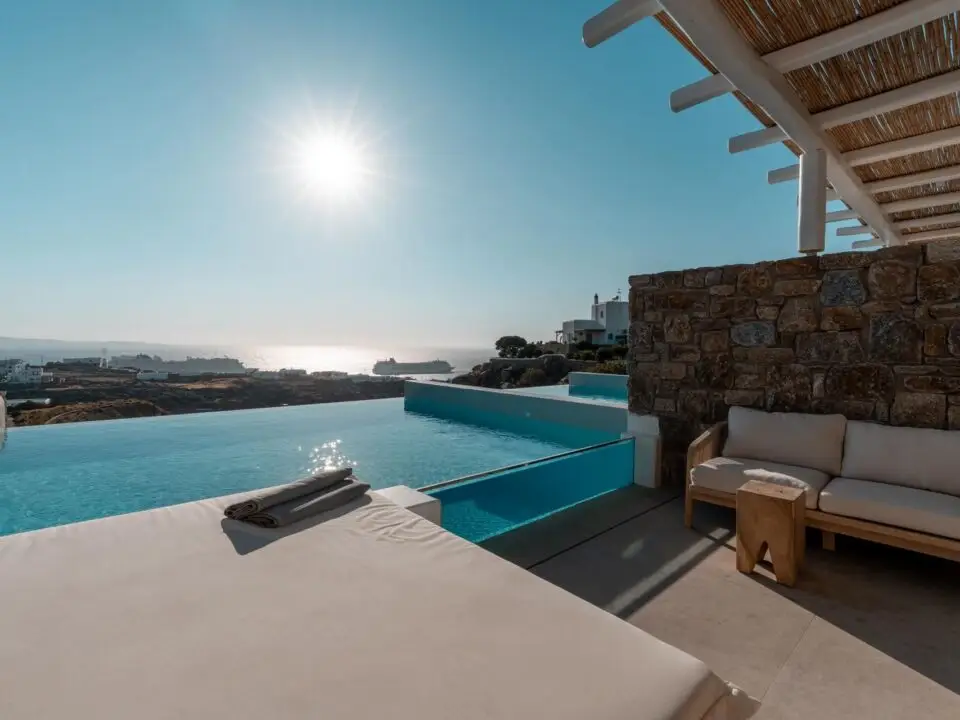 Premium Suite with Private Heated Swimming Pool: Luxury seaside suite terrace with infinity pool, lounge bed, and ocean view
