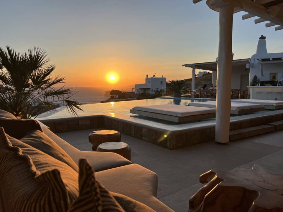 Nomia Mykonos Sunset Suites Lounge Area: Sunset over the infinity pool, with white villas and lounge seating