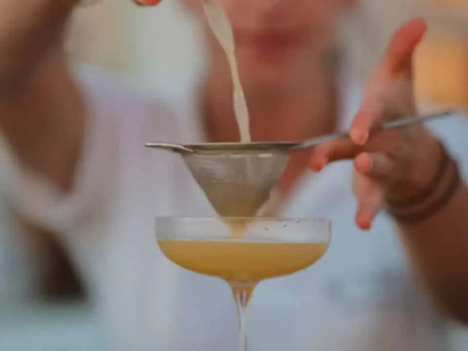 Nomia Mykonos Sunset Suites Bar: Bartender straining a cocktail into a coupe glass
