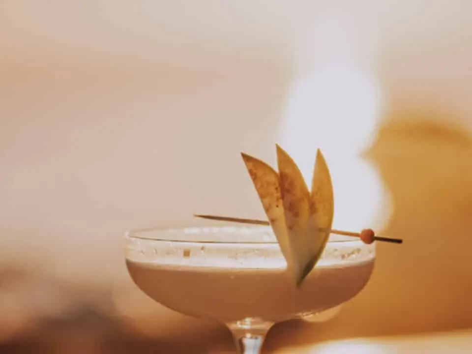 Nomia Mykonos Sunset Suites Bar: Martini Cocktail in a coupe glass garnished with sliced fruit and a skewer